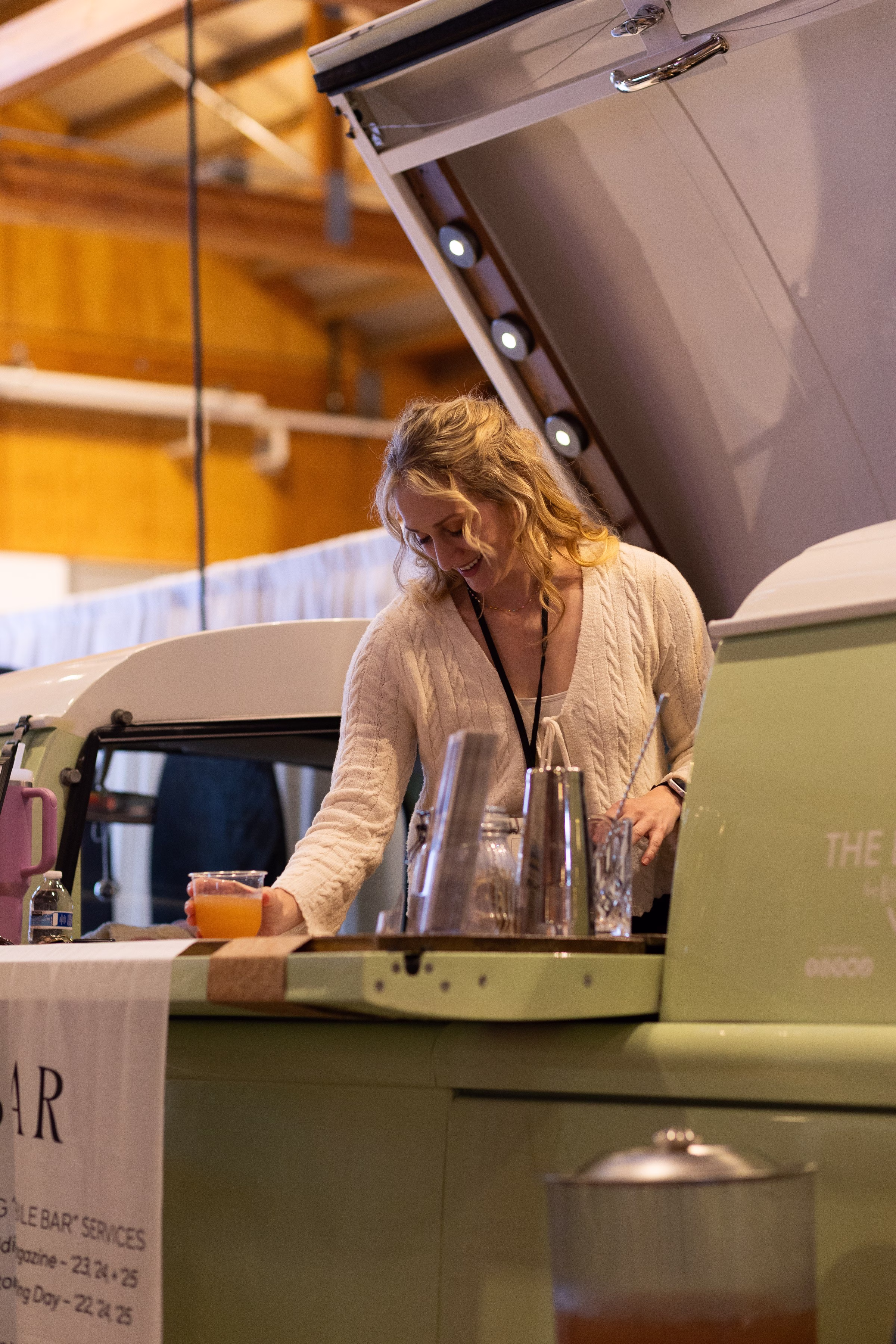 Professional bartender serving drinks at mobile bar setup at Salem wedding show