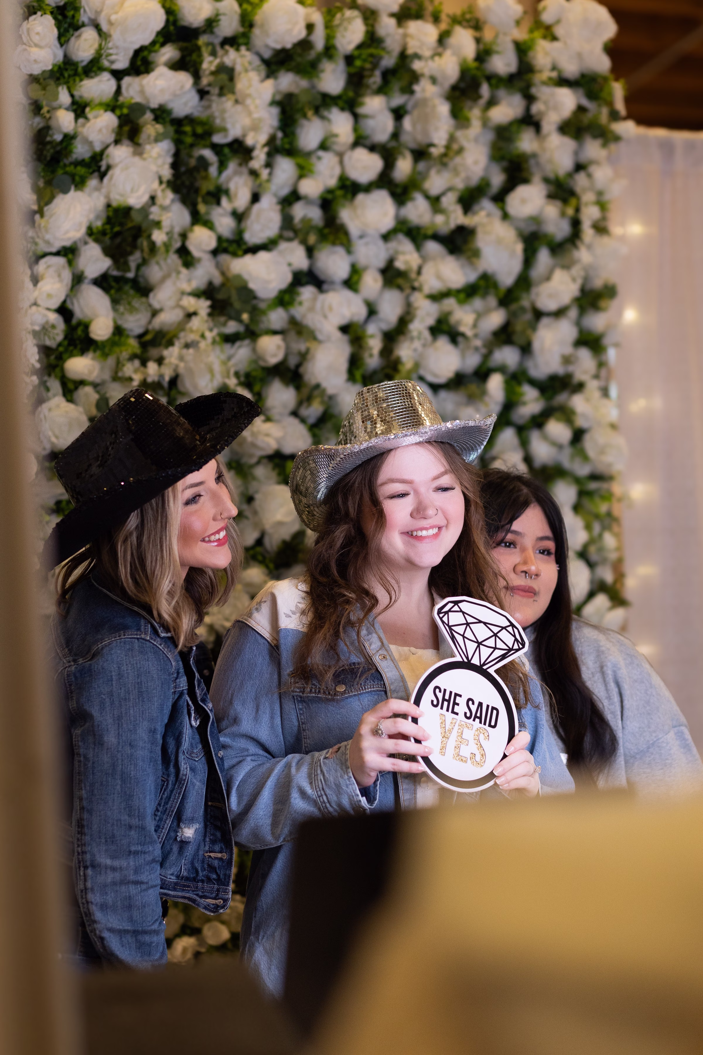 Three women posing with She Said Yes photo booth props and cowboy hats in Salem Oregon